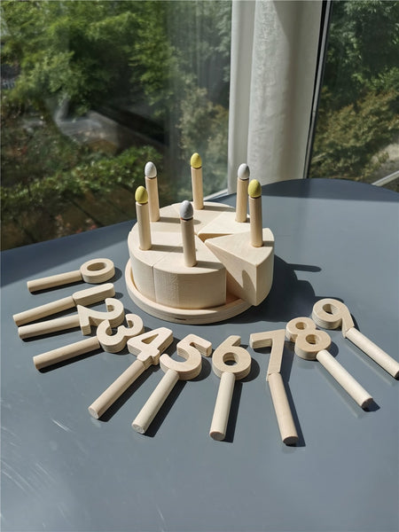 Toy wooden cake with numbers and candles